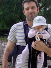 Ben Affleck with a baby in a baby carrier
