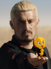 Tweety bird on a man's hand in still from Coyote vs. Acme trailer