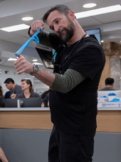 Noah Wyle about to shoot a rubber band in The Pitt