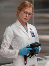 Nicole Kidman in Scarpetta. She is in a lab coat over a body