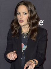 Winona Ryder pointing at something and looking like she's talking