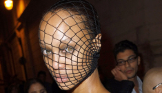 Tyra Banks covers her famous forehead with a cheap fishnet stocking
