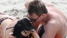 Daniel Craig kissing his girlfriend on the beach
