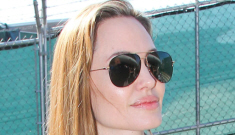 Angelina Jolie arrives at LAX, tells paps that she’s not wearing a wedding band
