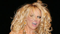 Pamela Anderson in a gold thong bathing suit on the runway at Fashion Week