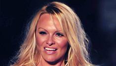 Pamela Anderson wears her stretched out Baywatch swimsuit on the catwalk