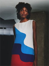 A model in a mod 60s wavy colorblock shift dress